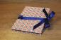 Preview: Leporello with diamond pattern in blue, red and white, blue satin bow